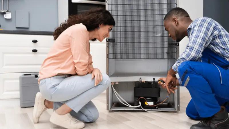 HVAC technician and homeowner inspecting new furnace