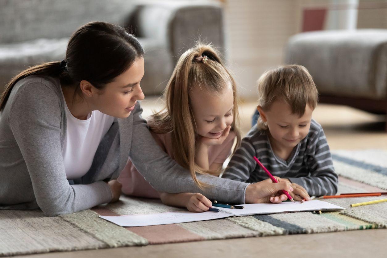 Mother and children writing together