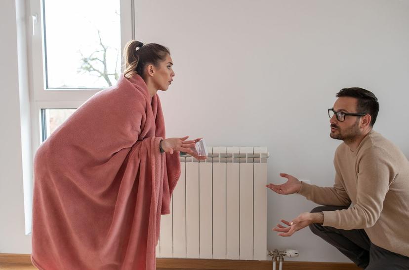 Couple disagreeing over their home's thermostat setting