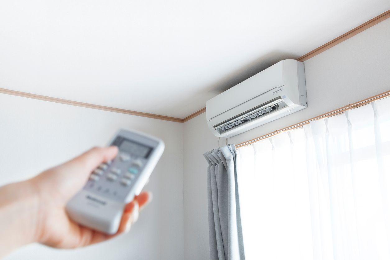 Homeowner adjusting the temperature of their ductless mini-split system