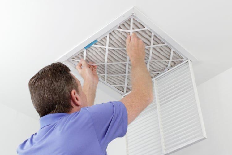Man installing HVAC filter