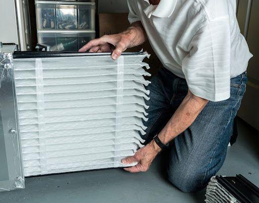 HVAC technician installing air filter