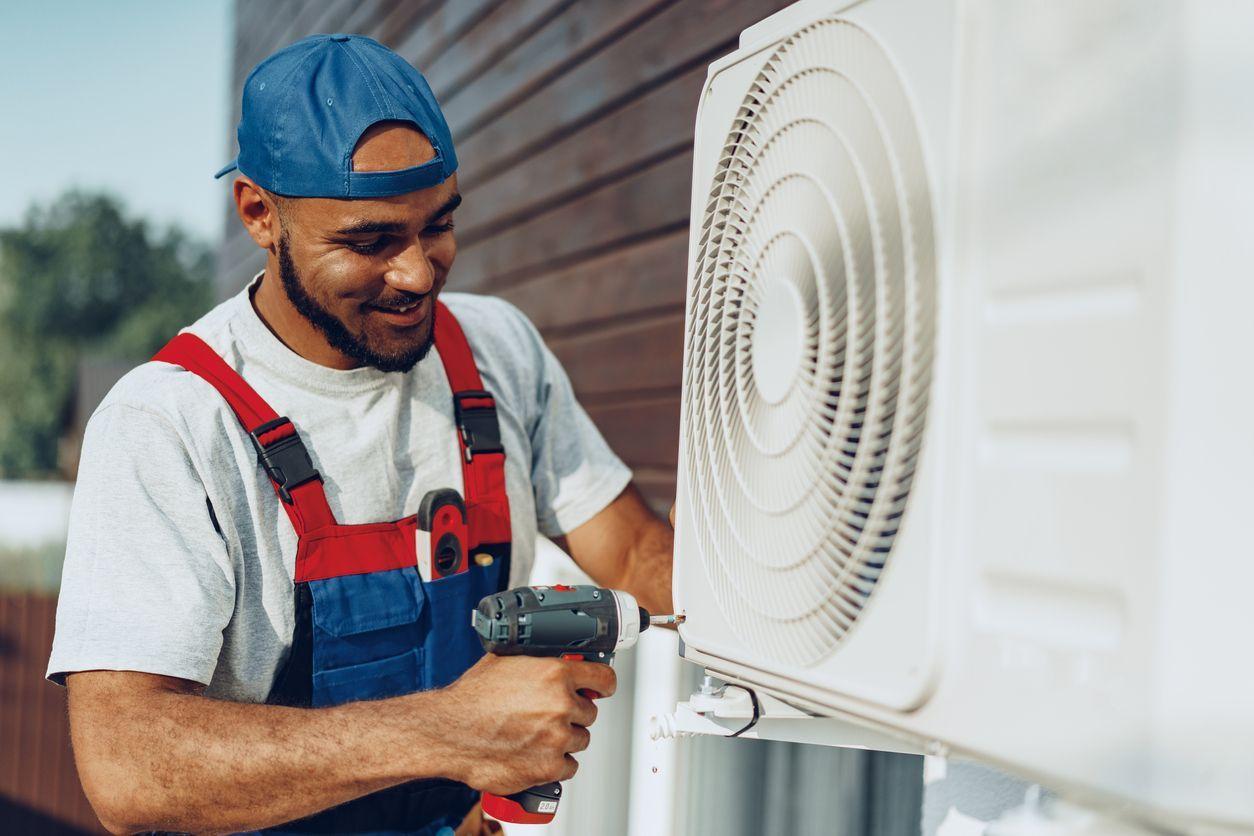 HVAC technician working on system