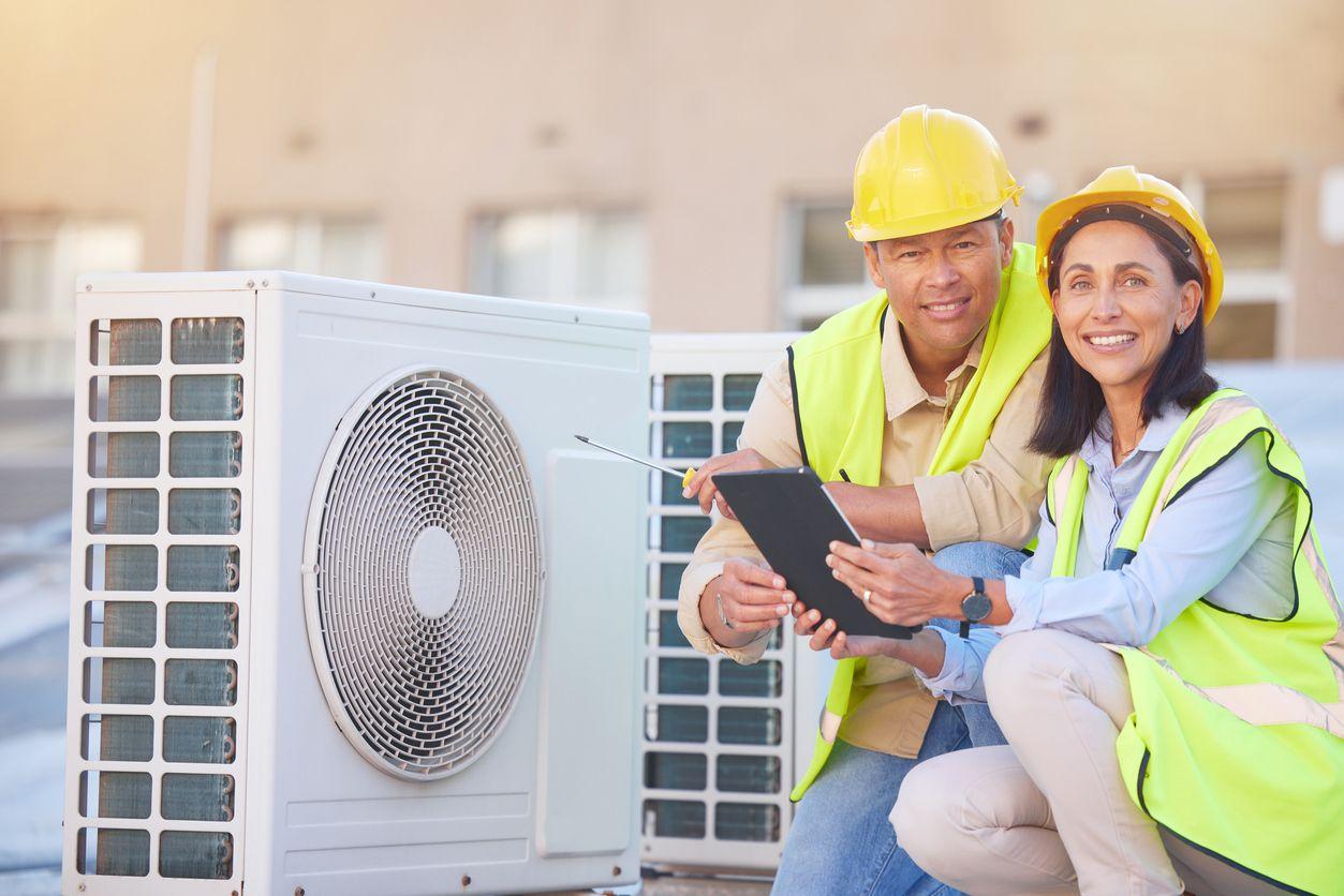 HVAC technicians inspecting heating and cooling system