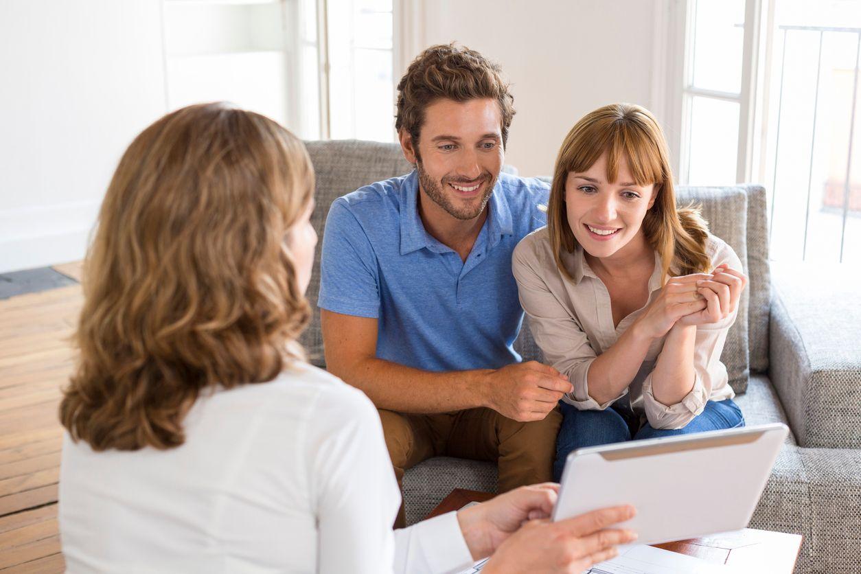 Couple looking over paperwork with woman