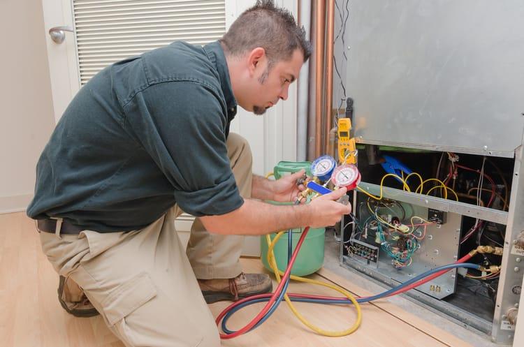 HVAC contractor performing AC maintenance
