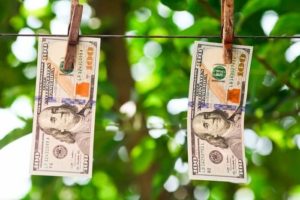 hundred dollar bills hanging on a clothesline