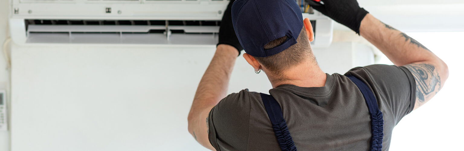 person fixing a mini split air conditioner
