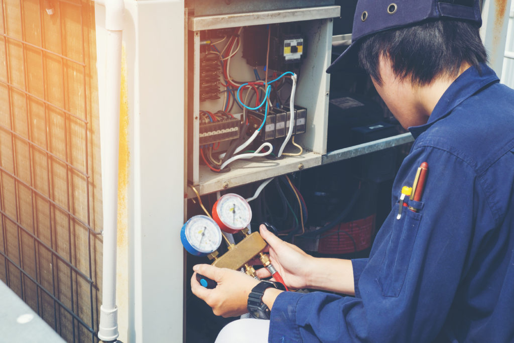 Man repairs HVAC unit