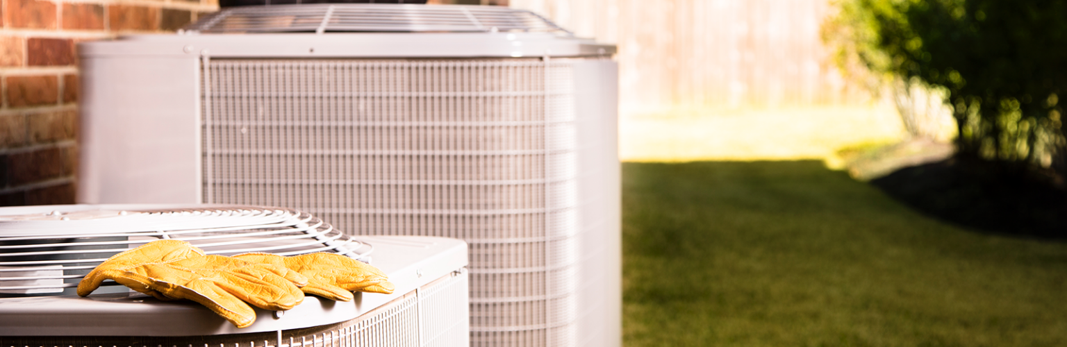 air conditioners with tool bag and gloves on top