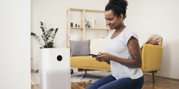 person adjusting their air purifier on their phone