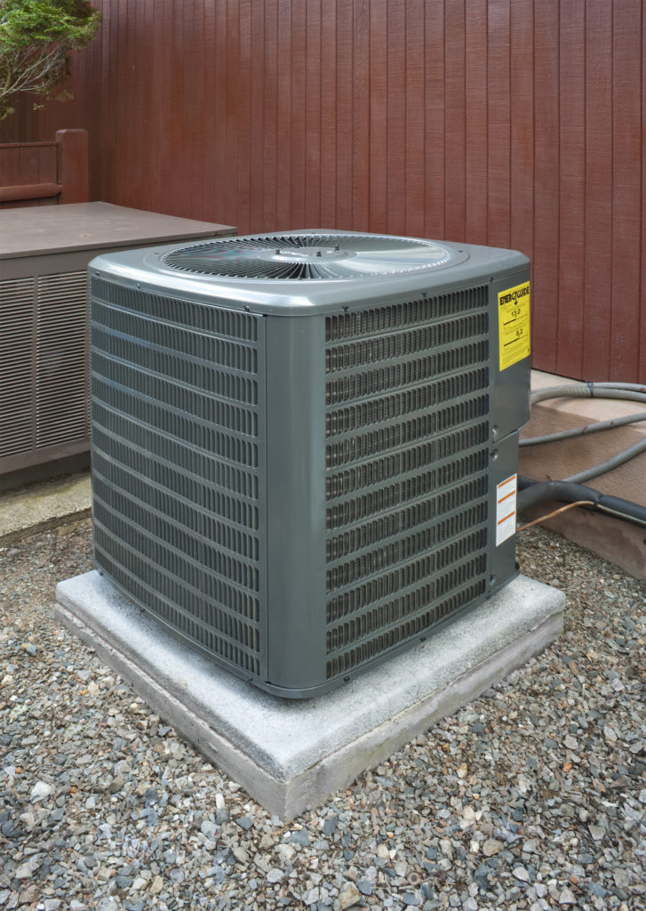 heat pump next to fence