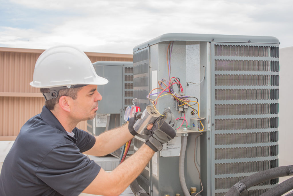 man installs hvac unit