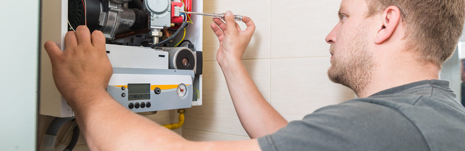 technician repairing gas furnace