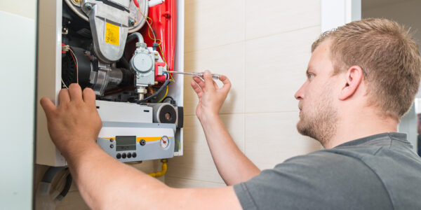 technician repairing gas furnace