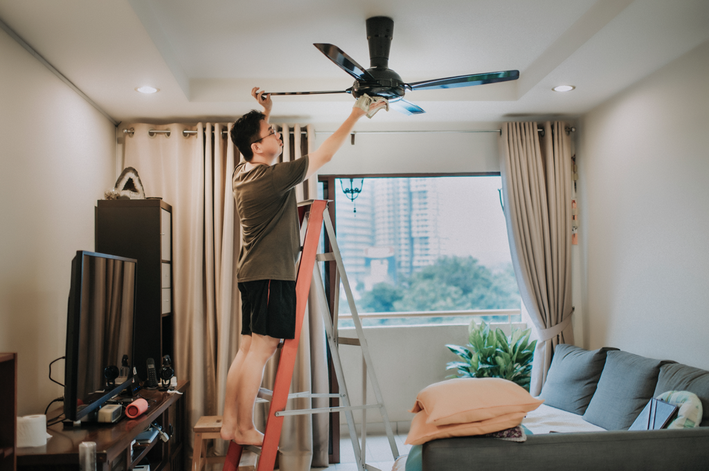 man-repairing-ceiling-fan