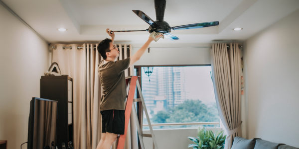man-repairing-ceiling-fan
