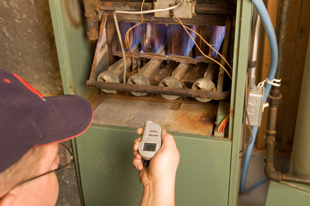 man-turning-on-furnace