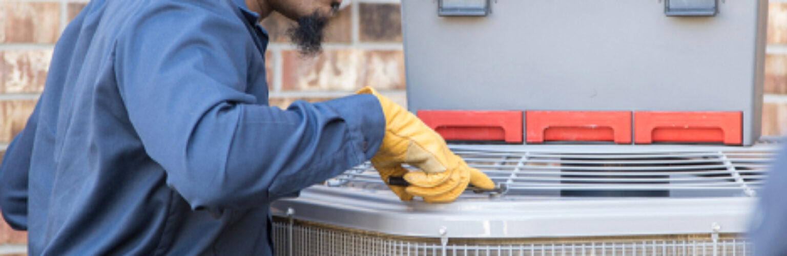 person inspecting an hvac unit