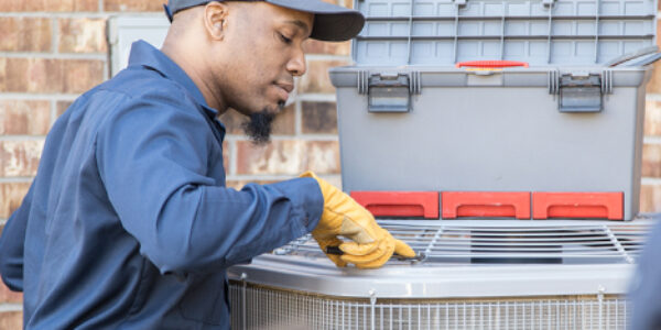 person inspecting an hvac unit