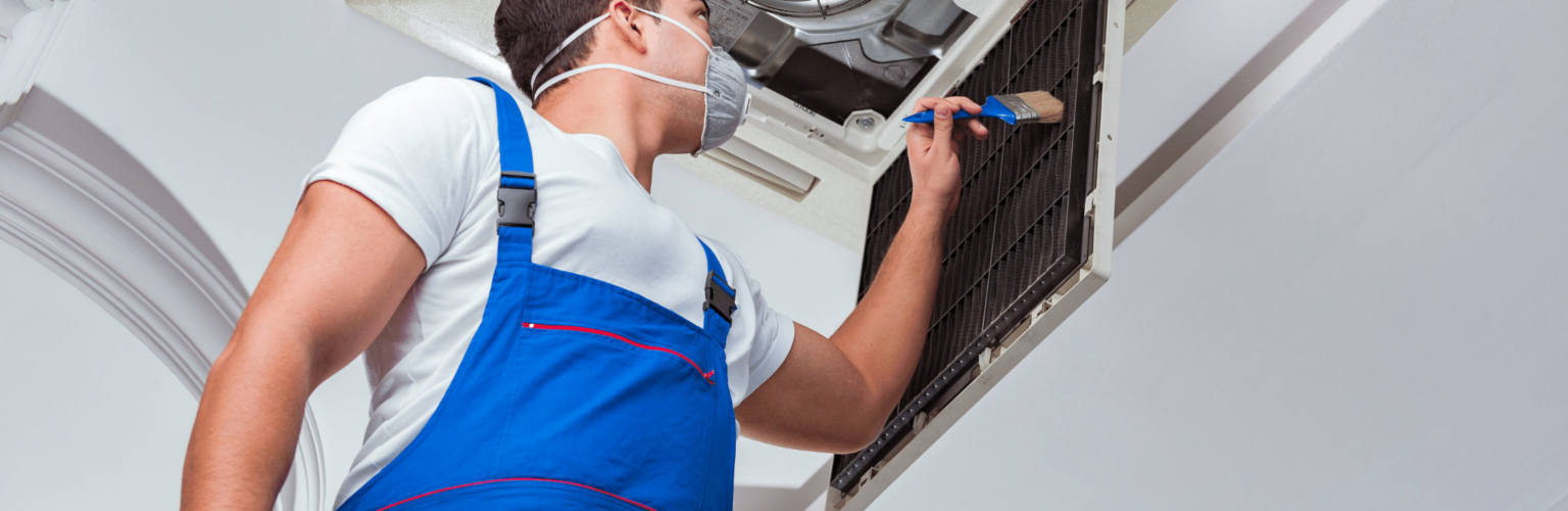 person cleaning air conditioner