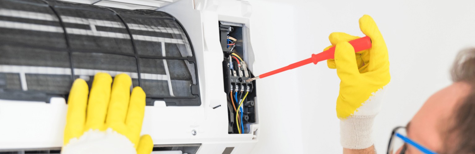 person fixing mini split