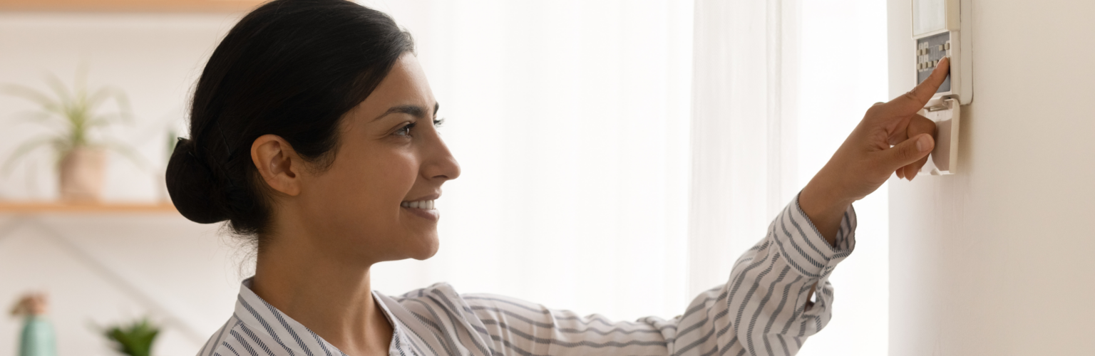 woman checking thermostat
