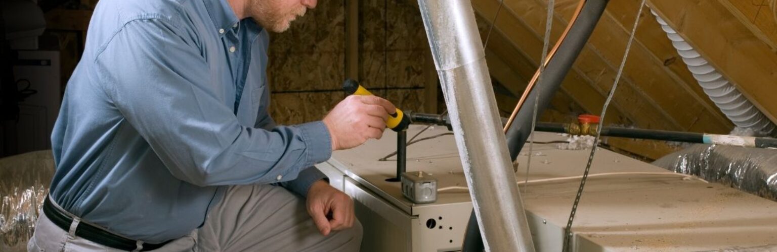 man fixing Lennox furnace