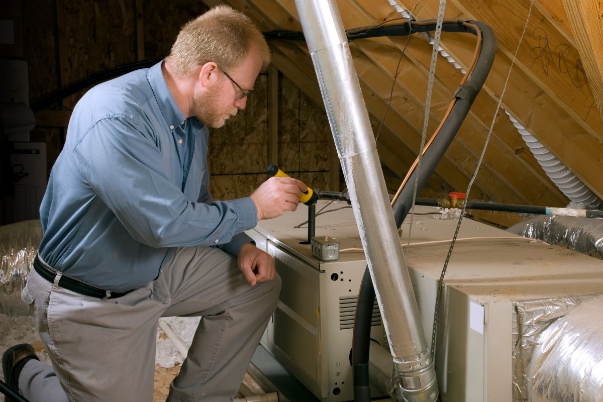 man fixing Lennox furnace