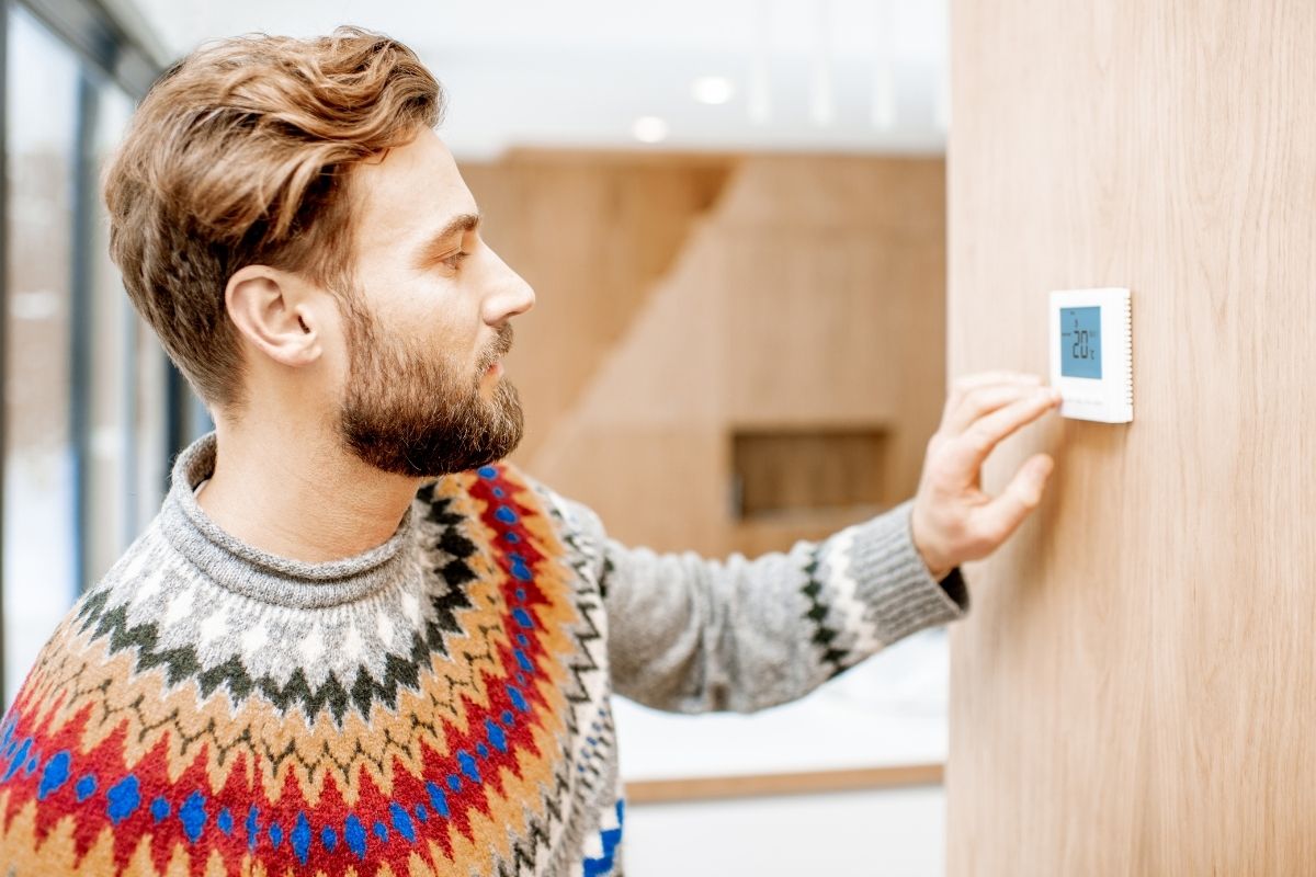 guy looking at Lennox thermostat