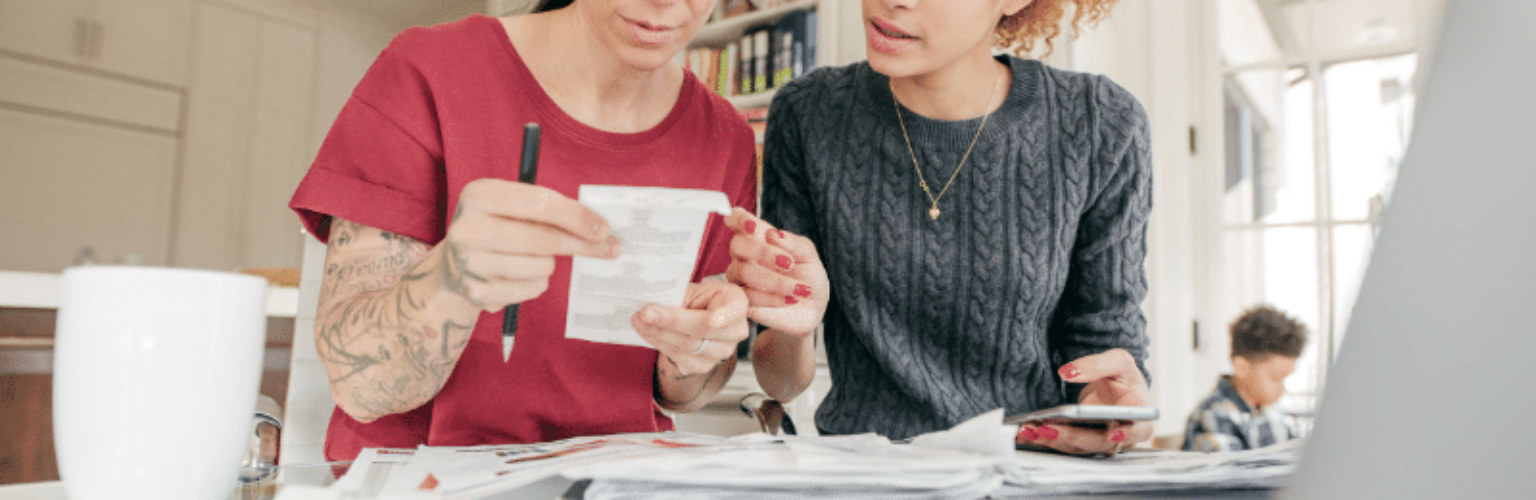 two women looking at receipts