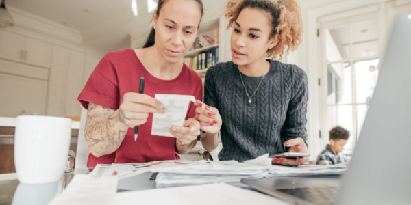 two women looking at receipts