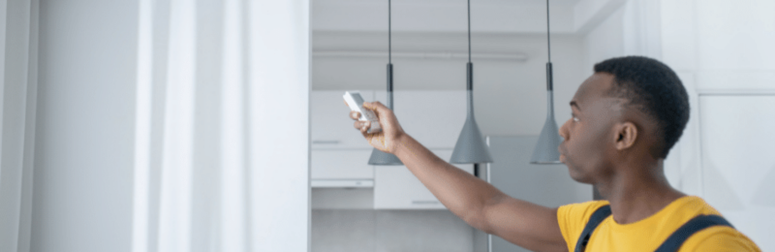 man controlling ductless unit remotely