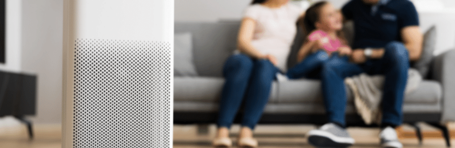 family in large room with air purifier