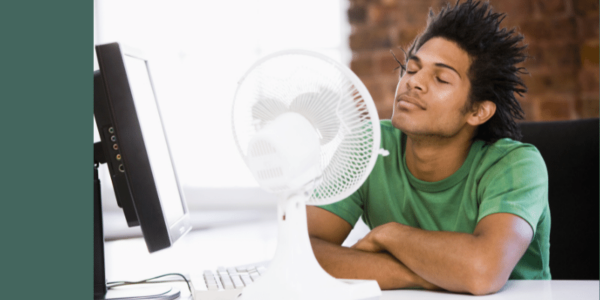 man sitting in front of fan