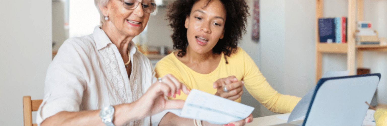 women paying bills at kitchen table