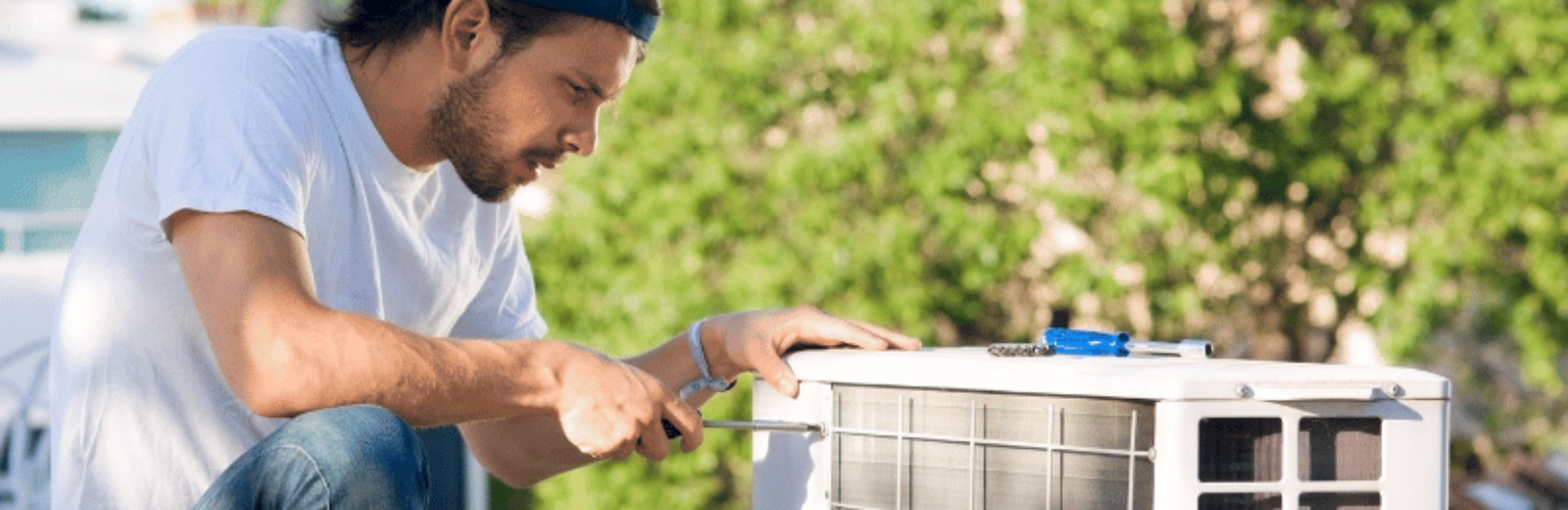 repair man installing heat pump