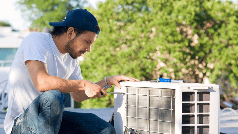 repair man installing heat pump