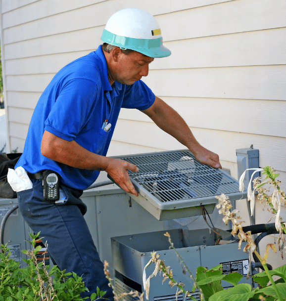 AC repair man fixing condenser